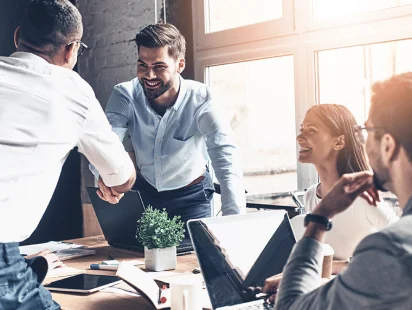 Two-men-shake-hands-during-finance-meeting