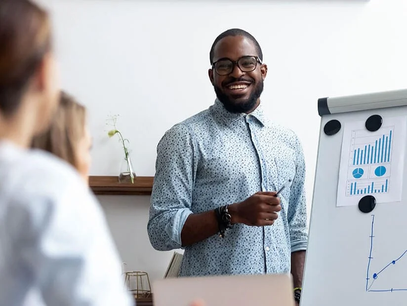 man presenting charts on whiteboard 1