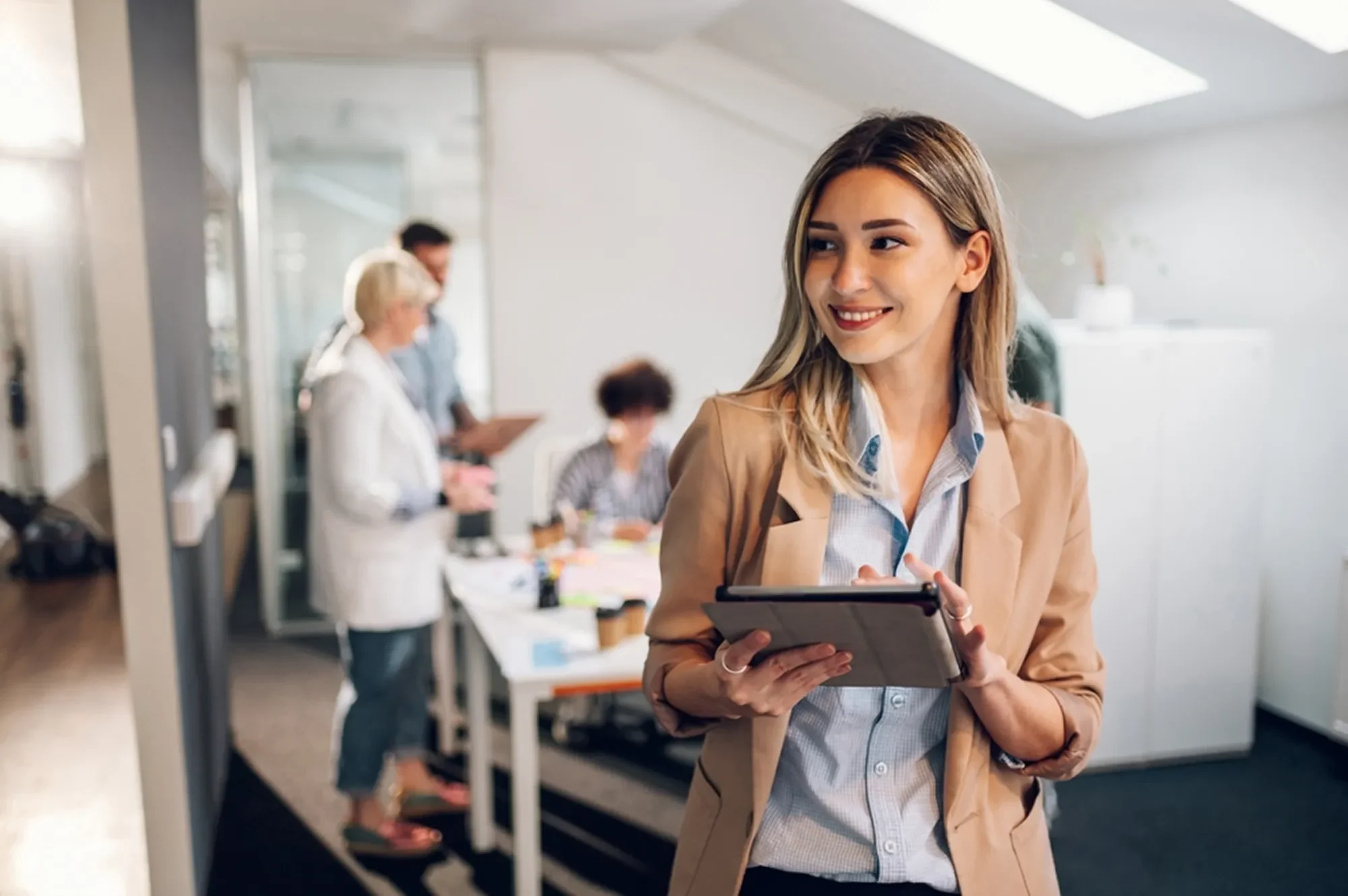 Business Tax Minimization 19 woman leading team in office 2155412093 1 e1764074467421